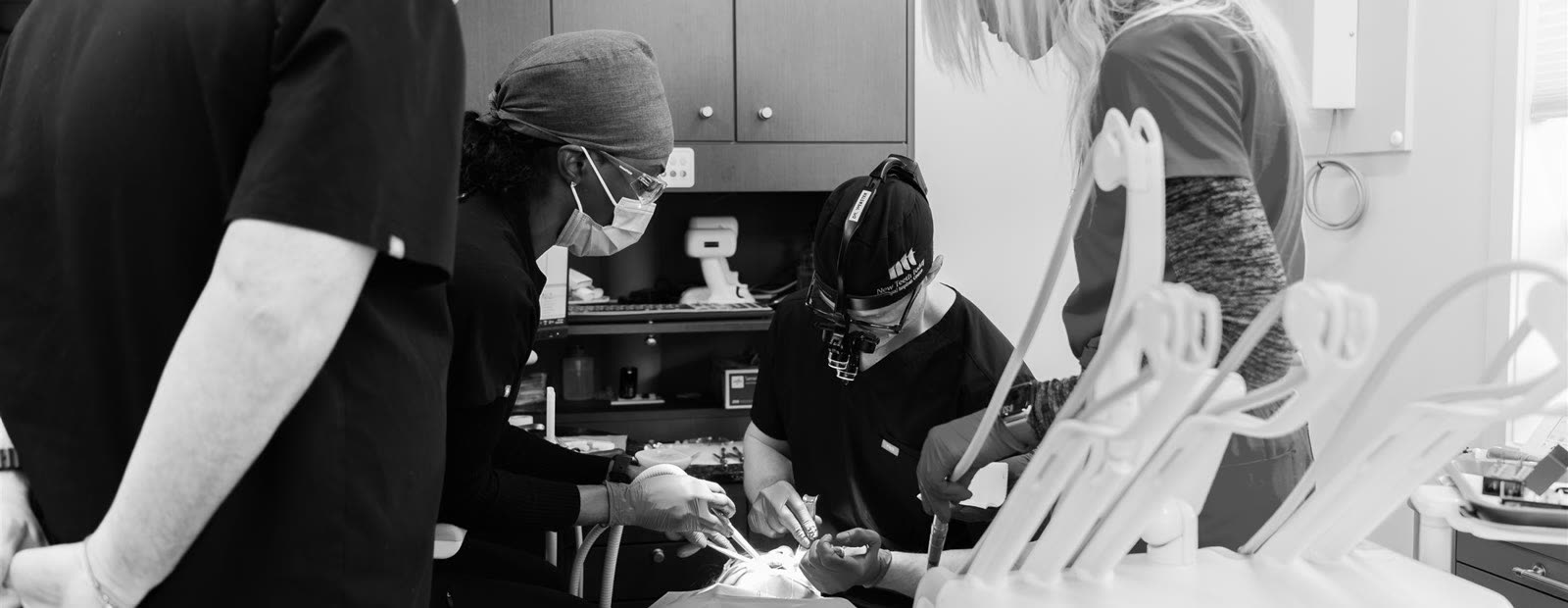 A surgical team at work around the chair.